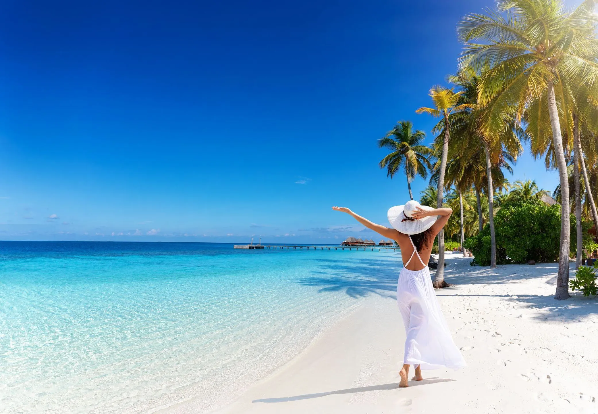 Woman relaxing on the beach, representing financial freedom